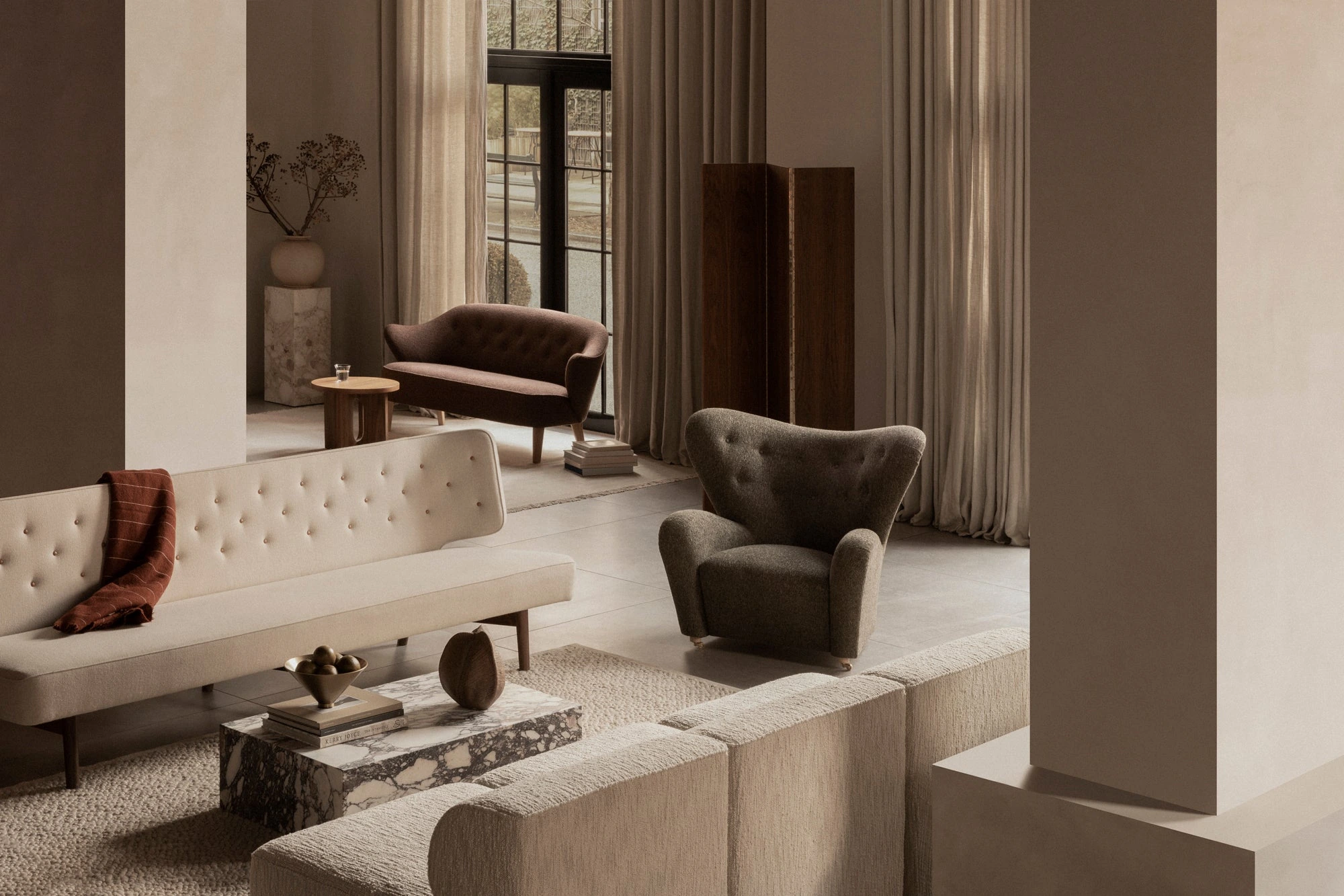A Danish design reference from Audo Copenhagen, with neutral upholstery and warm interior materials