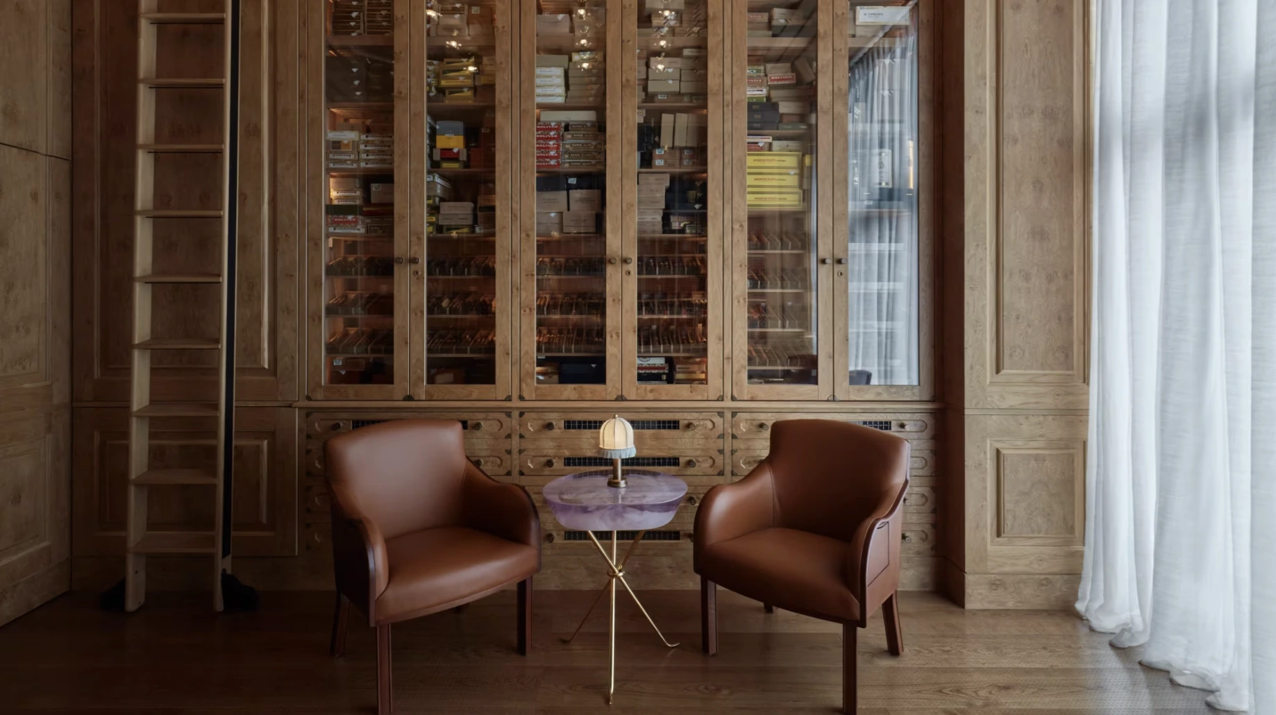 Wood-panelled cigar salon with leather chairs and a humidor